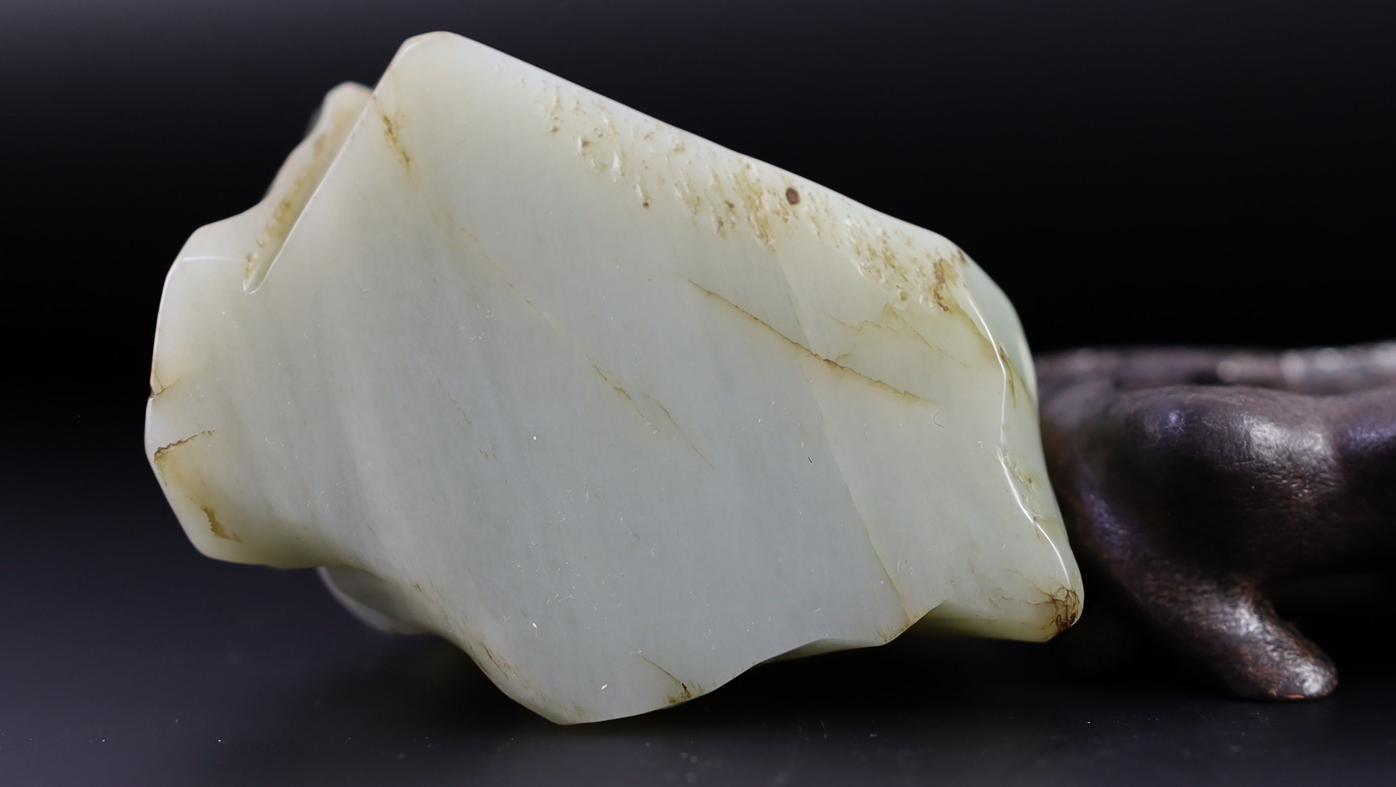 A Chinese pale celadon jade ‘Sanqing’ boulder carving, 18th century, 9.5cm high, 12 with wood stand